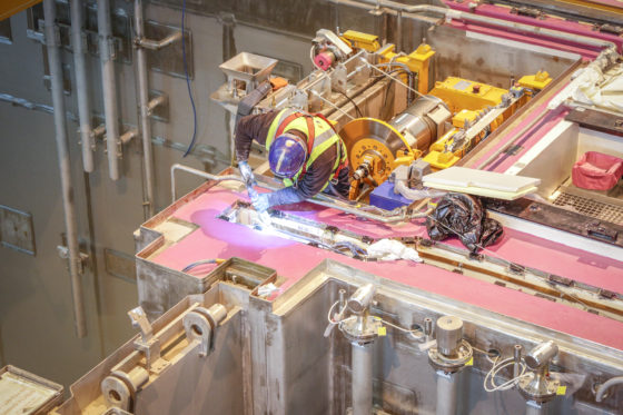 A worker welding an engine to prevent fire